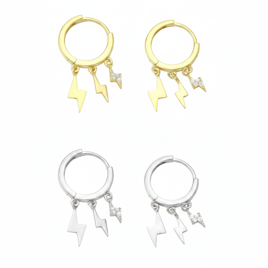 Two pairs of earrings, one with gold plating and the other with silver plating, each featuring a small loop with three dangling charms in the shape of thunders, set with cubic zirconia.